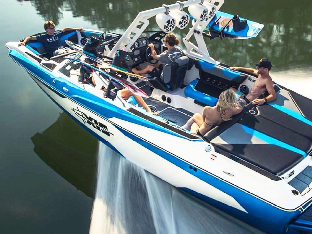 a blue and white boat sitting next to a body of water