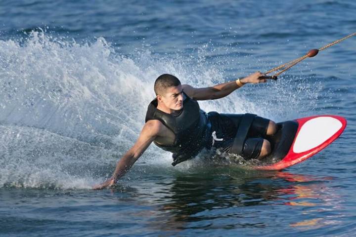 a young man riding a wave on a surfboard in the ocean