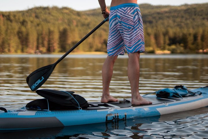a person riding a surf board on a body of water