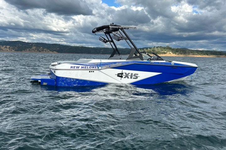 a blue and white boat floating on a body of water